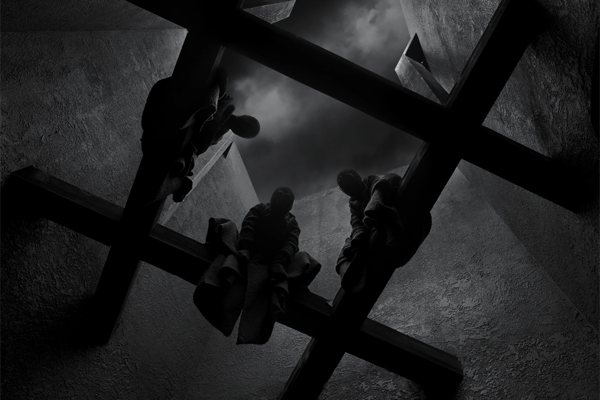 Black and white image of witches perched on an open ceiling
