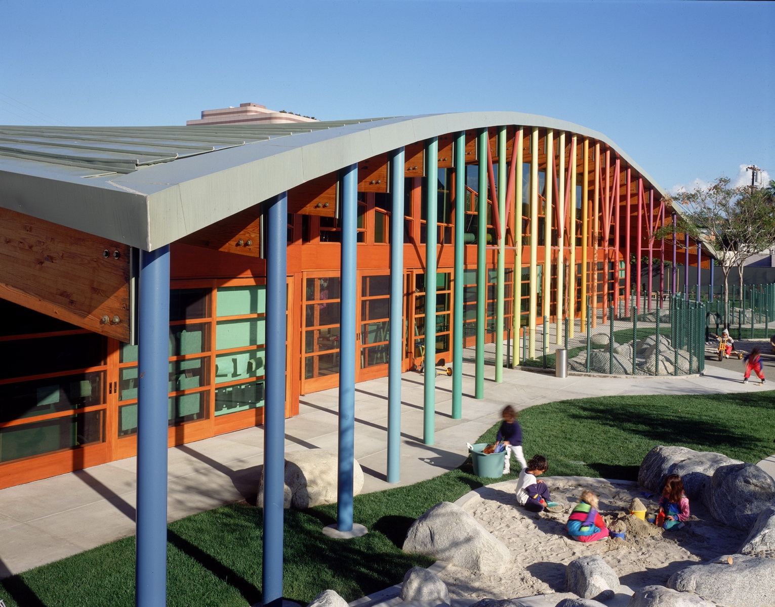 multicultural modernist building by architect Steven Ehrlich for Sony Child Care multi colored columns and rounded arch roof