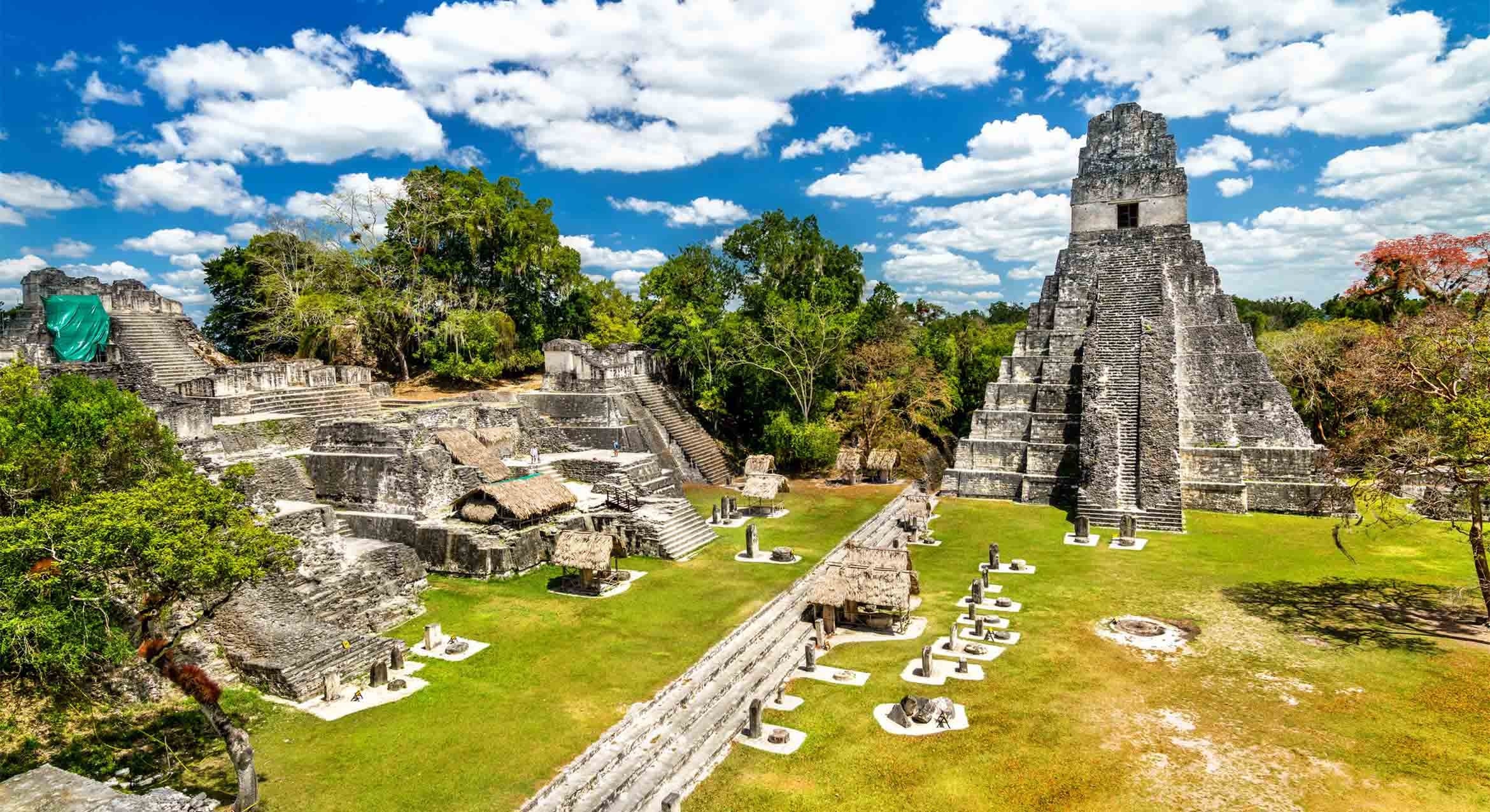 Ruins of an ancient temple beneath a blue sky and clouds