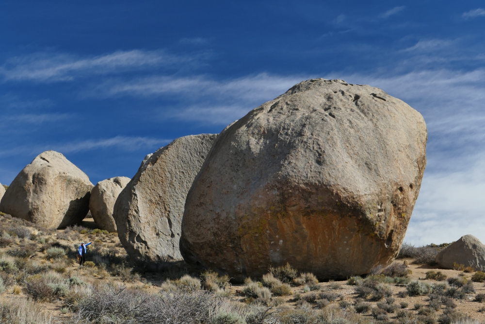 The Peabody boulders in the Buttermilk boulder field dwarf a nearby hiker