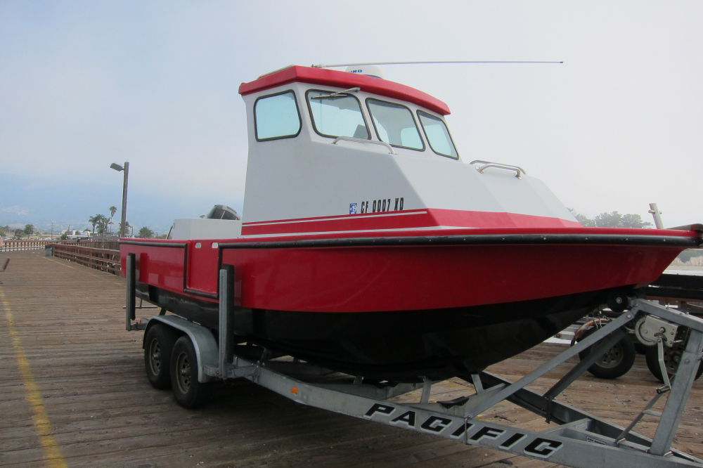 red fishing boat sitting on a trailer