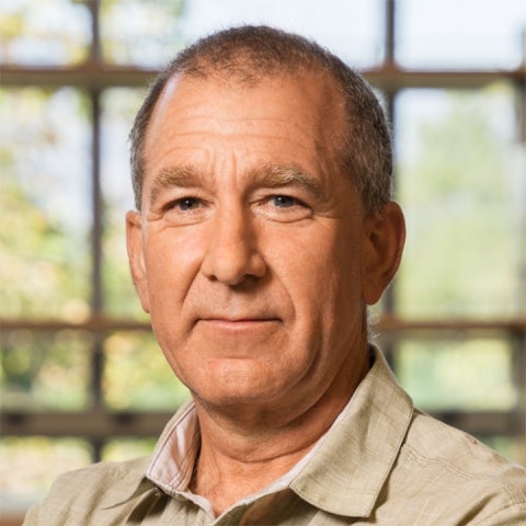 Daniel Blumenthal wears a tan collared shirt inside