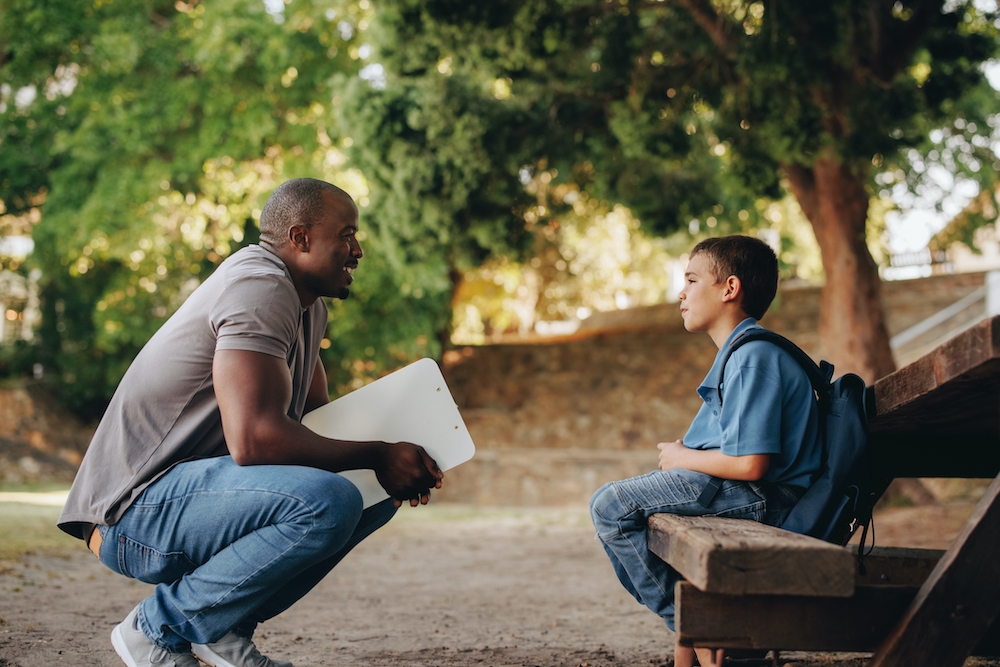A school psychologist speaks with a young student