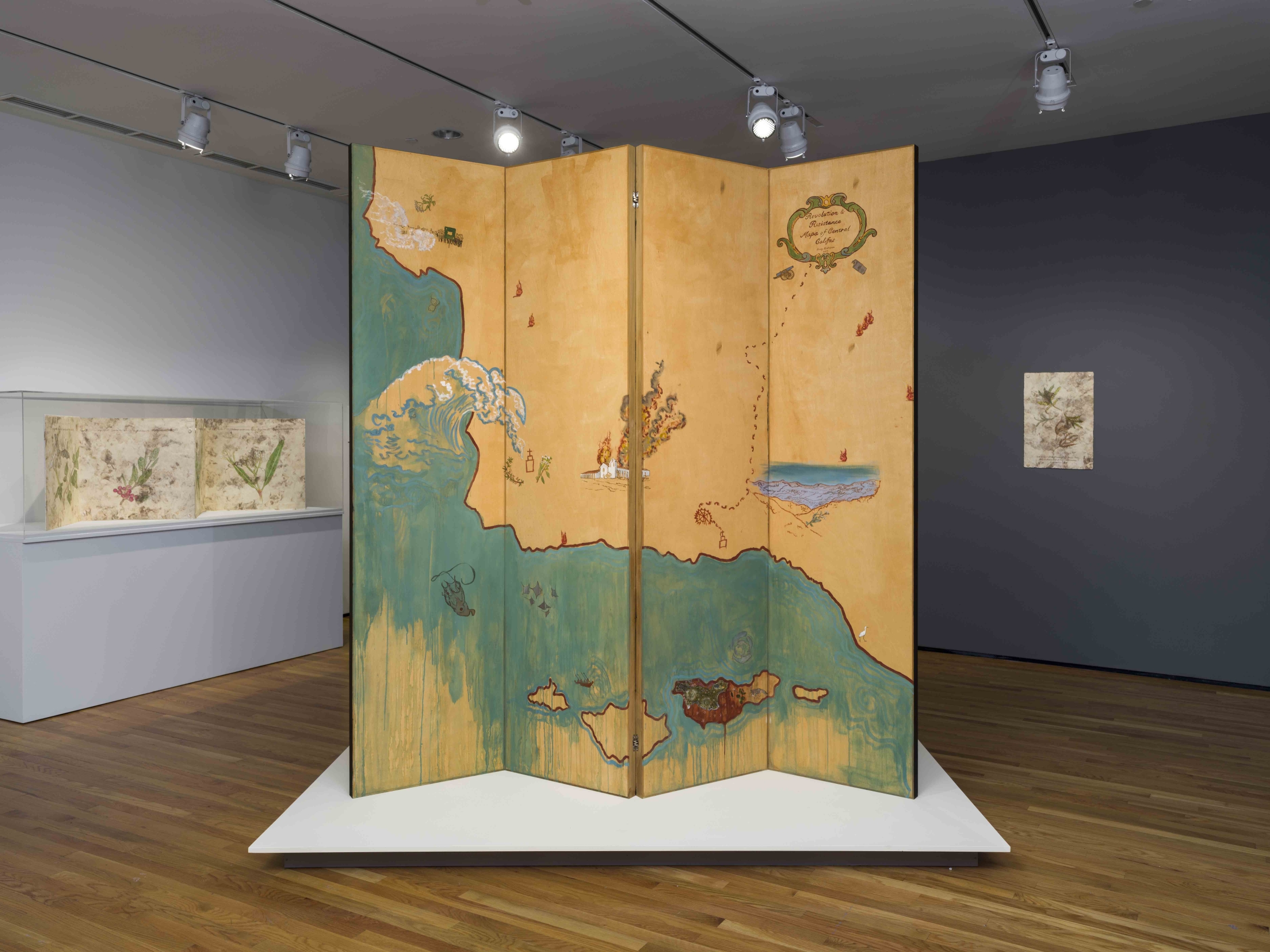 A large, artist-created map standing in the middle of a gallery