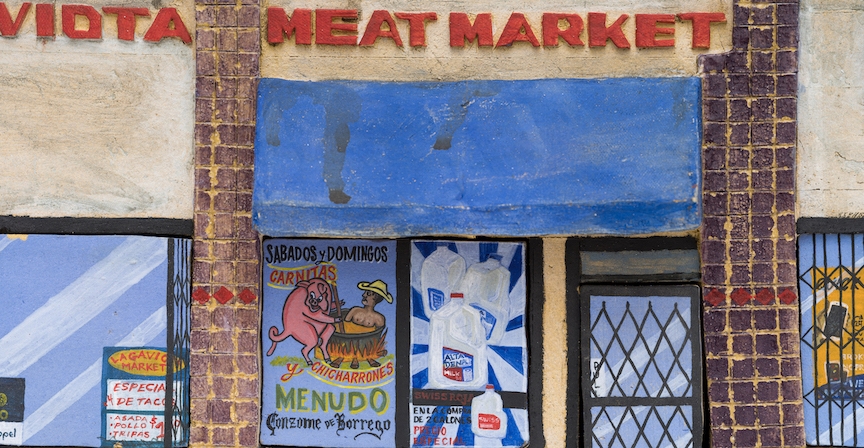 Ceramic reproduction of a meat market store front.