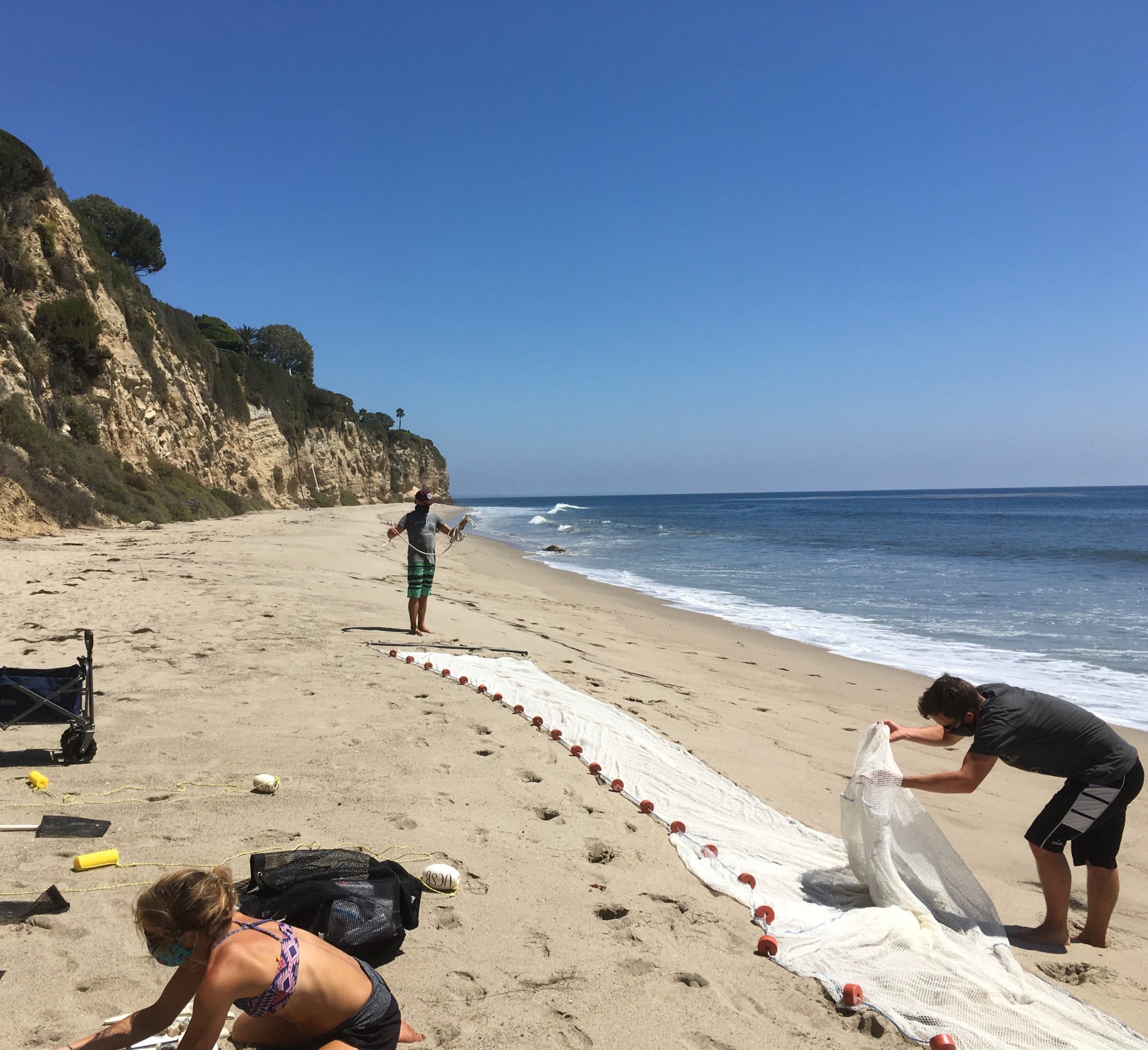 researchers setting up a seine to monitor fish populations