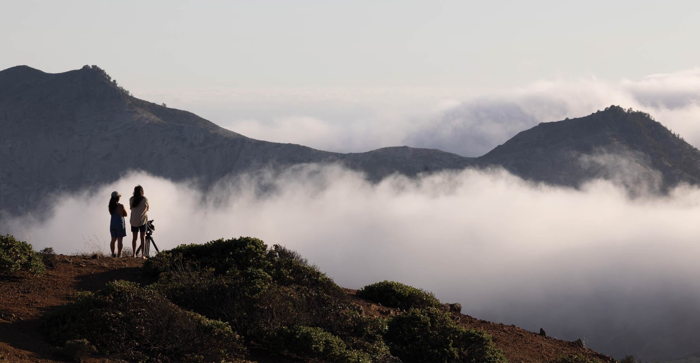 Silhouette of filmmakers above a canyon on Santa Cruz Island