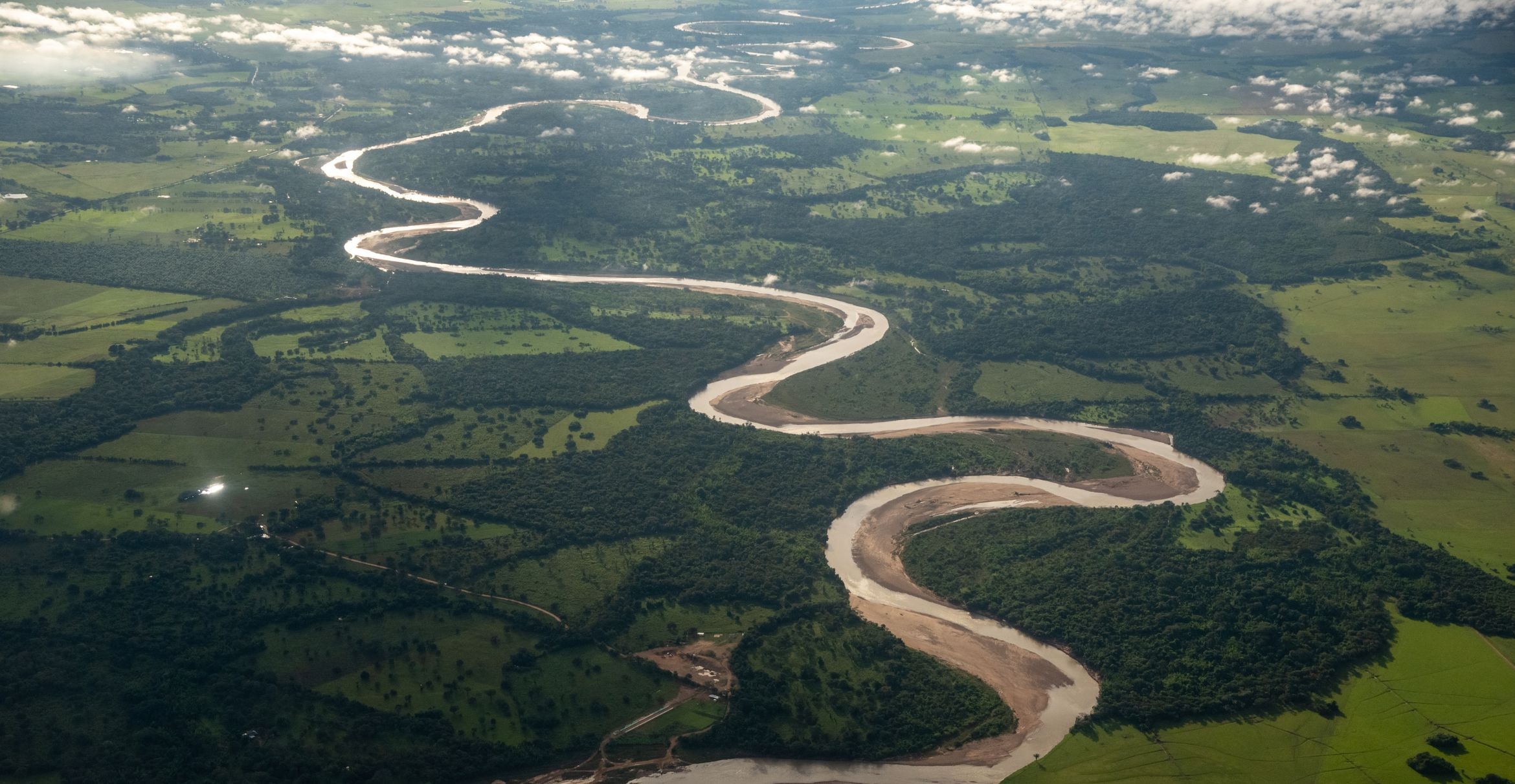 A river meanders through forests and fields in Columbia.