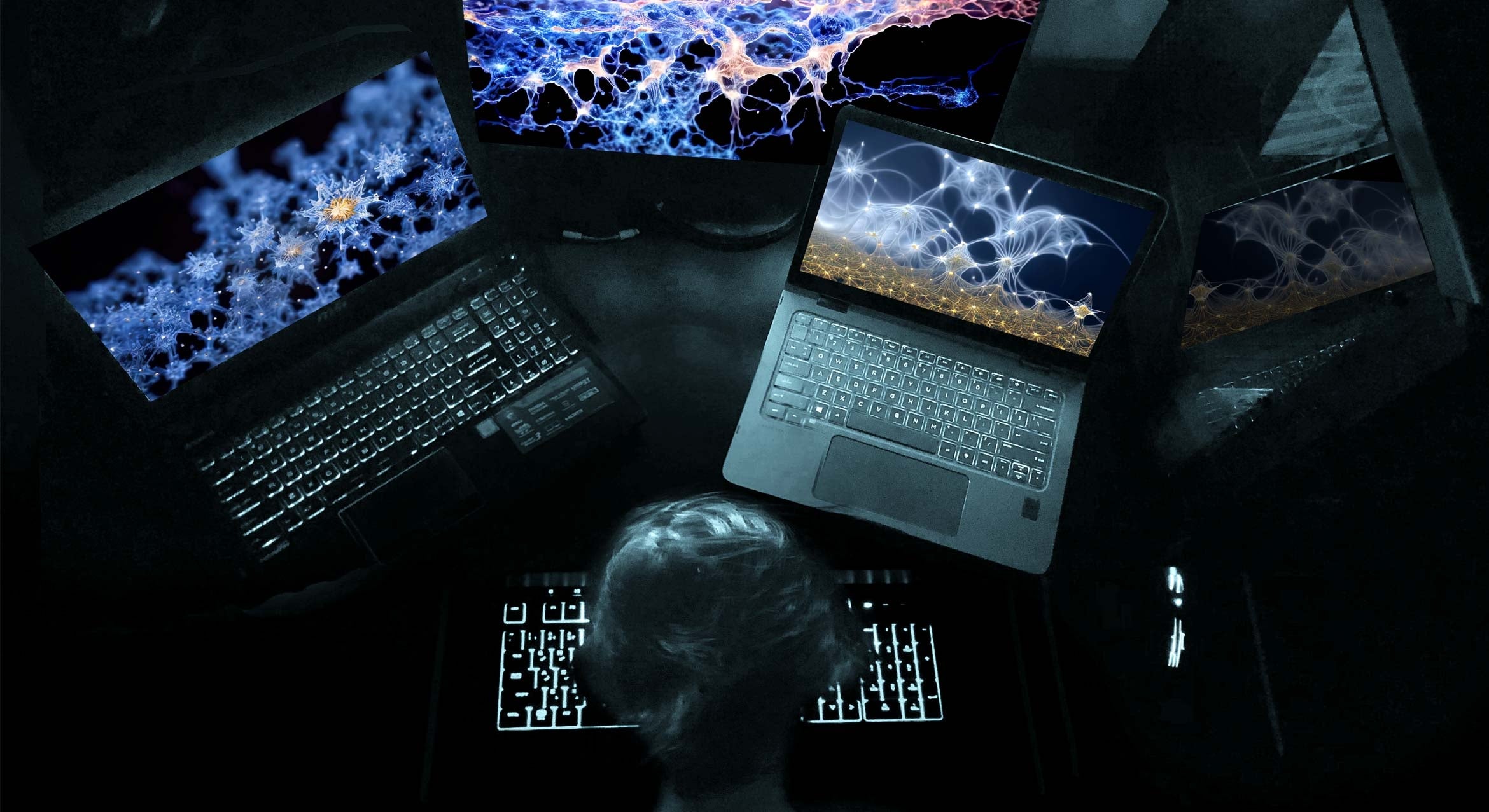 computer screens on desk with abstract images and woman's head from behind