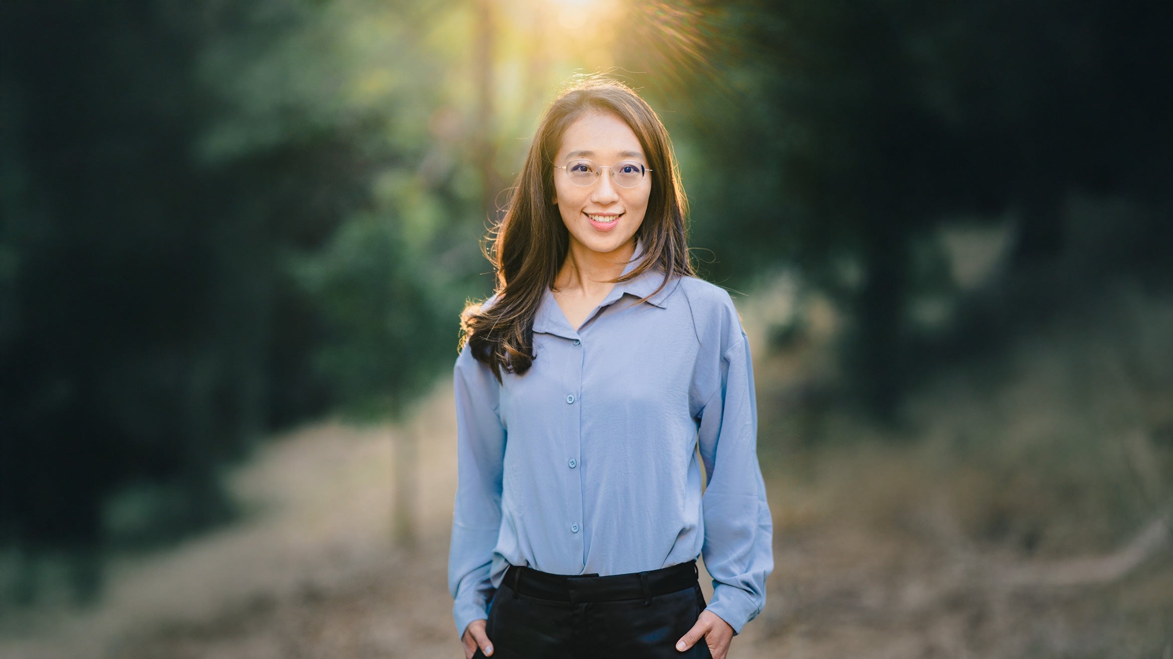 woman with dark hair in forest