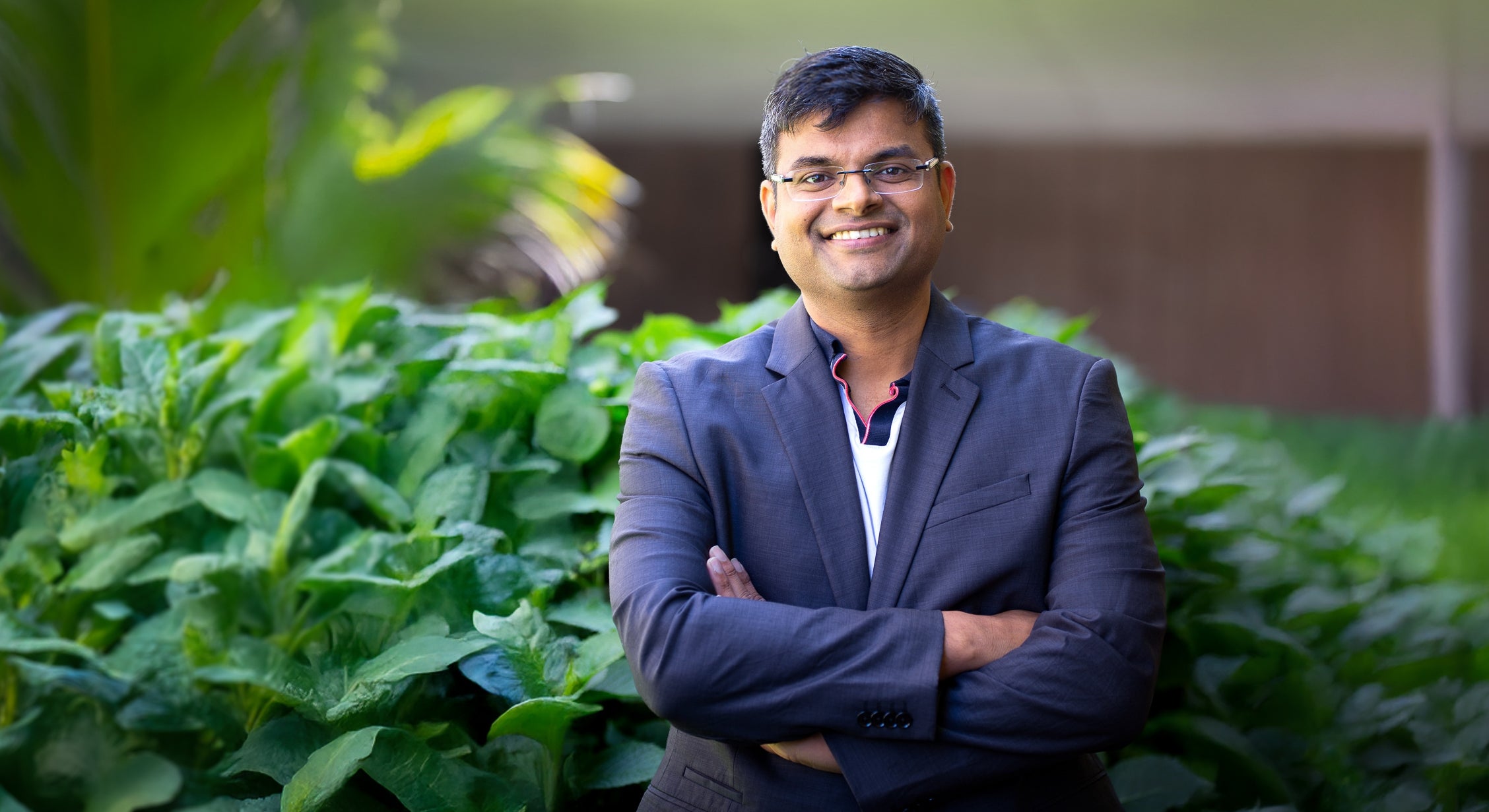 man of East Asian descent in suit smiling