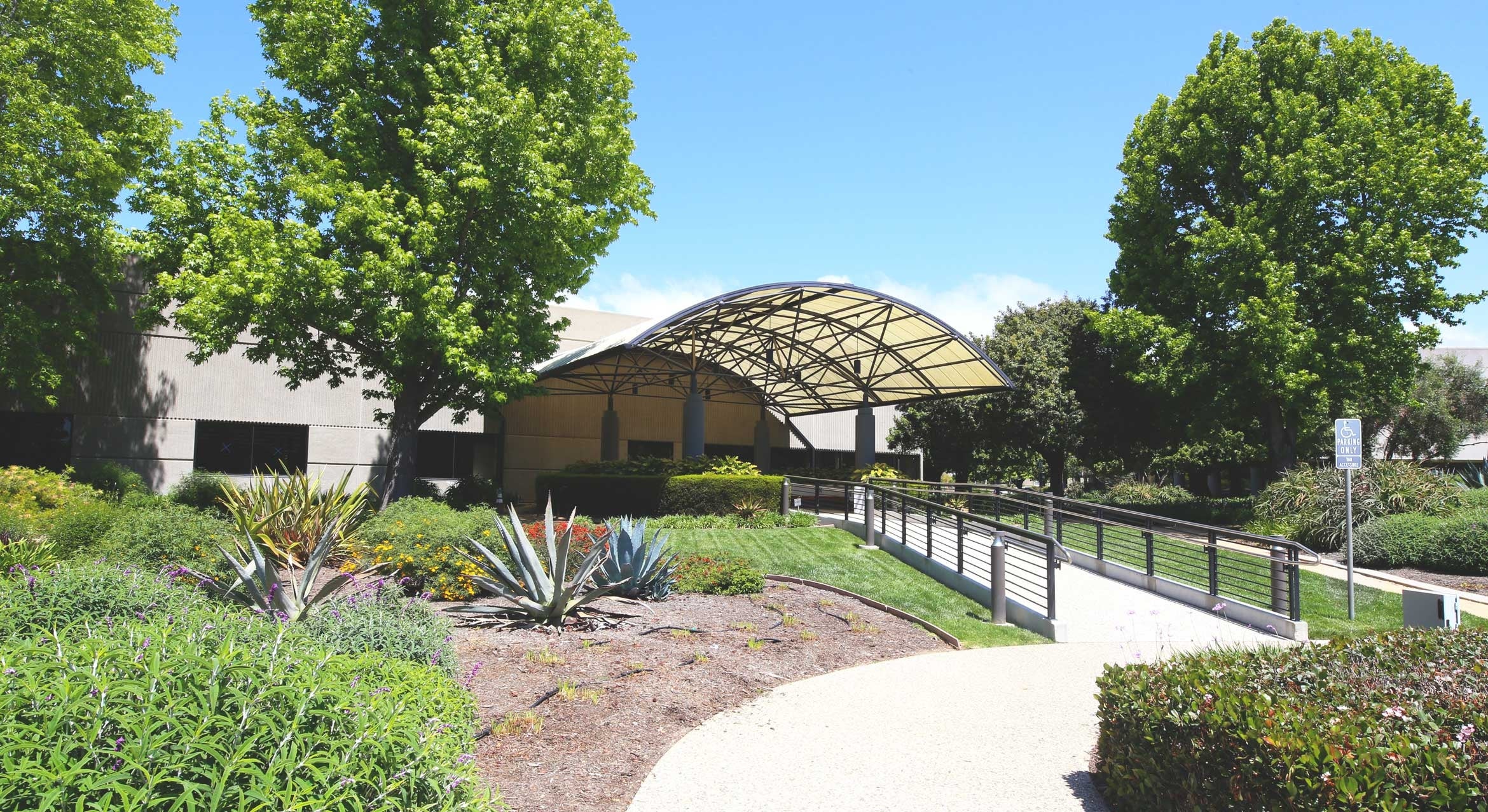 front of building with landscaping sunny day