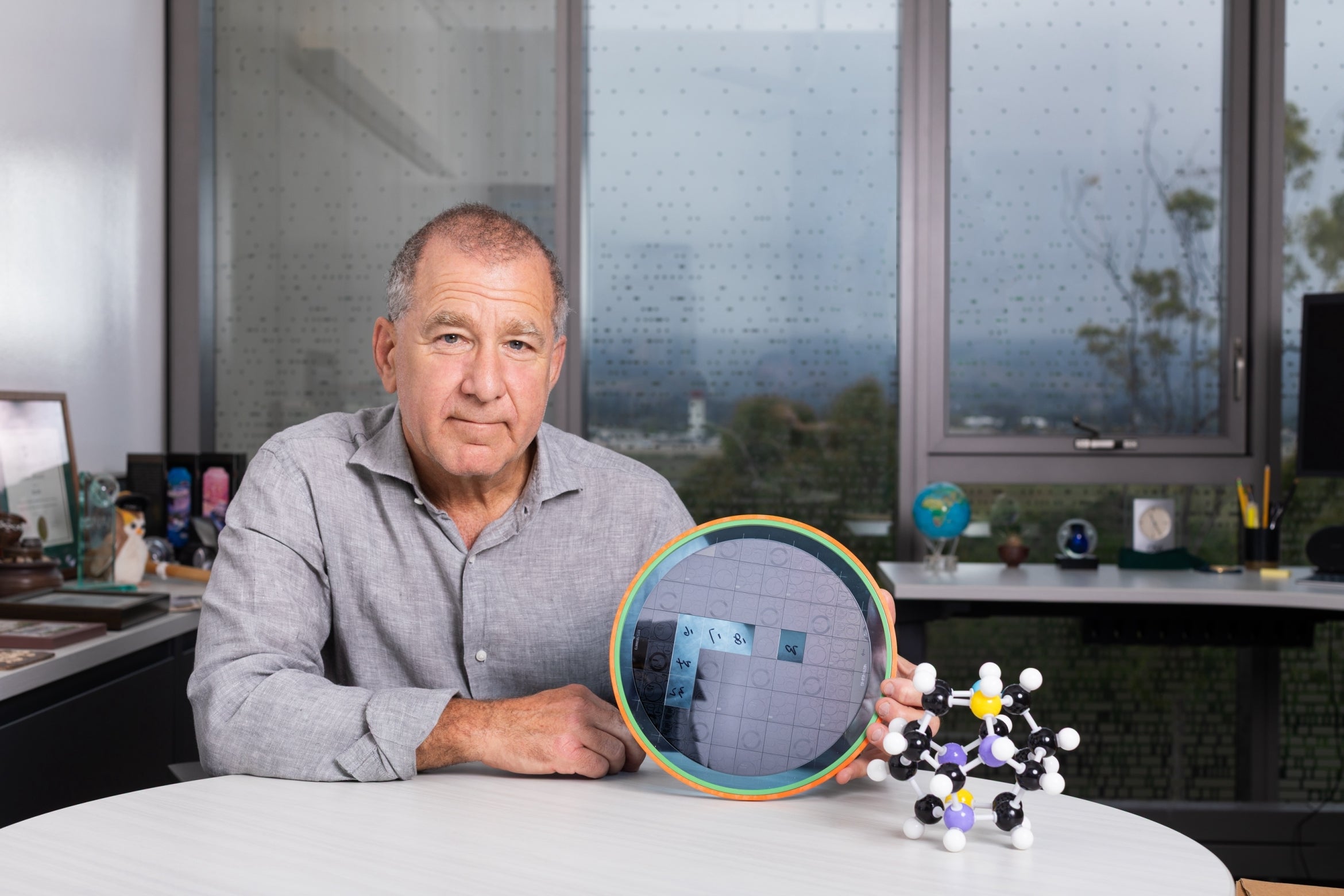 scientist holds a wafer of chips developed for deployable quantum experiments