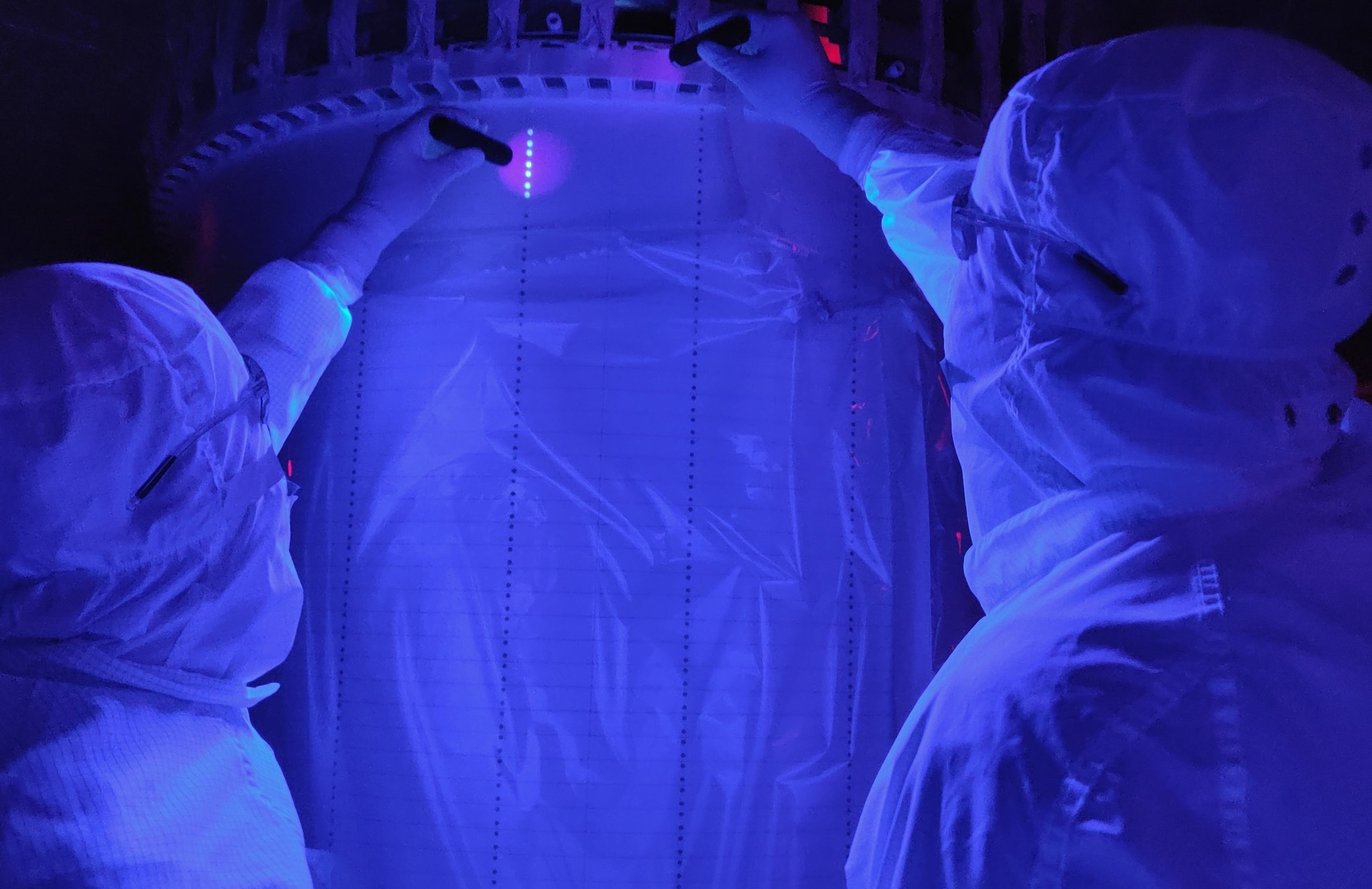 researchers scanning equipment in UV light