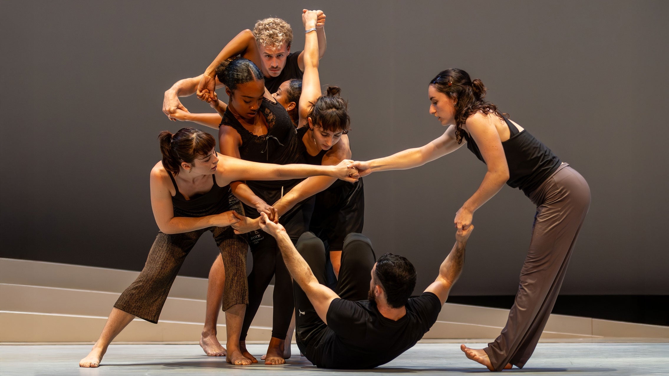 modern dancers with arms and legs intertwined